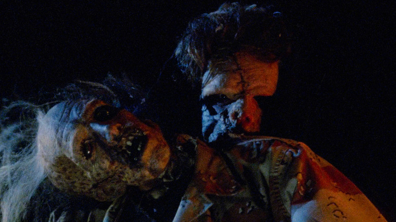 Leatherface hiding behind corpse