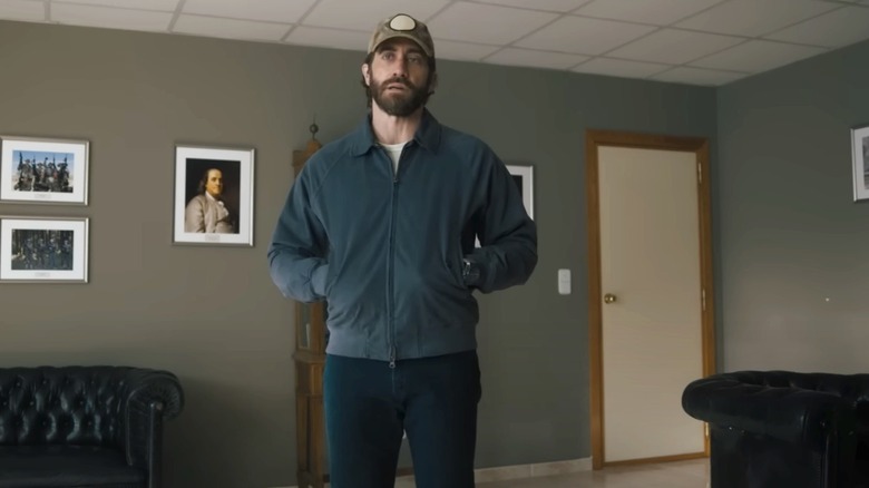 Kinley stands in room in blue jacket