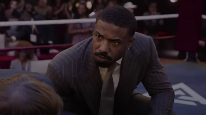 Adonis Creed kneels next to a beaten fighter