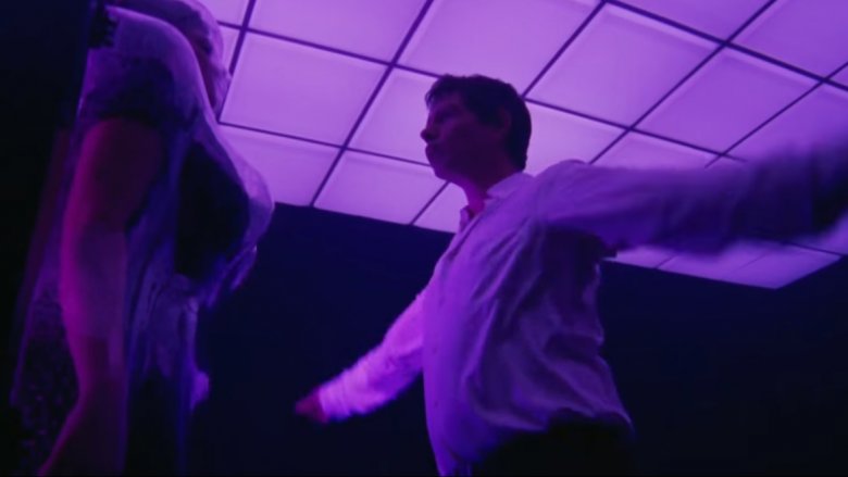 Ben Mendelsohn dancing in pink-neon room