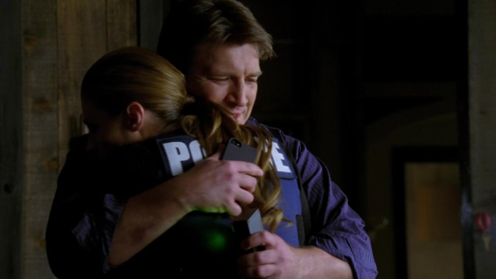 Stana Katic and Nathan Fillion hug on Castle