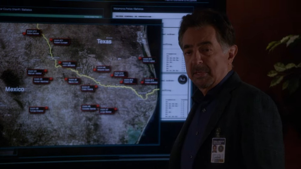 Rossi standing next to map