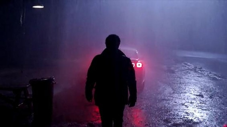 Skull Tattoo Man walking toward car in the rain