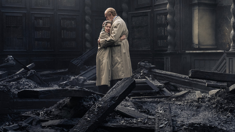 Elizabeth and Philip embrace in burned Windsor Castle