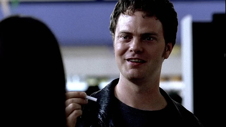 Rainn Wilson as Guy in Supermarket holding a cigarette