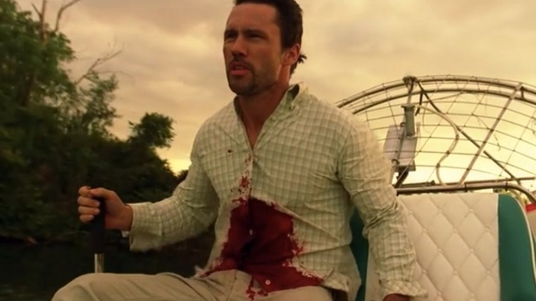 Todd Kendrick in a boat with blood on his stomach