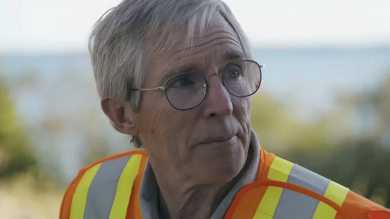 Craig Tester looks up while wearing a reflective vest on The Curse of Oak Island (2014-present)