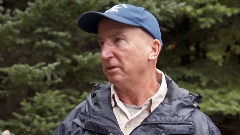 Gary Drayton in blue cap and windbreaker talking on The Curse of Oak Island (2014-present)