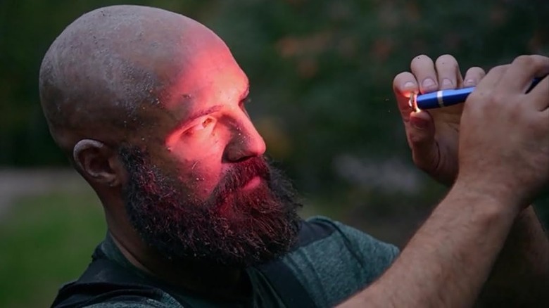 Jack Begley looks into a flashlight on The Curse of Oak Island (2014-present)