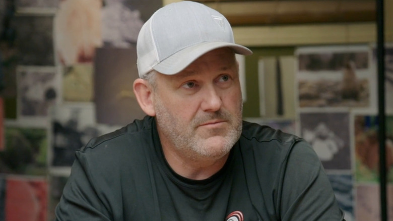 Scott Barlow wears a gray baseball cap in the Oak Island war room on The Curse of Oak Island (2014-present)