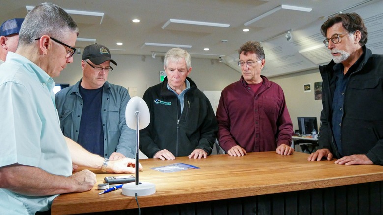 oak island team examines coin