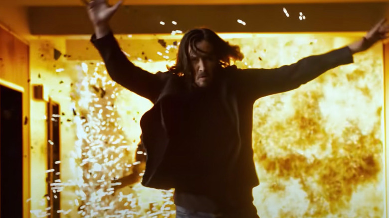 Neo jumping away from explosion