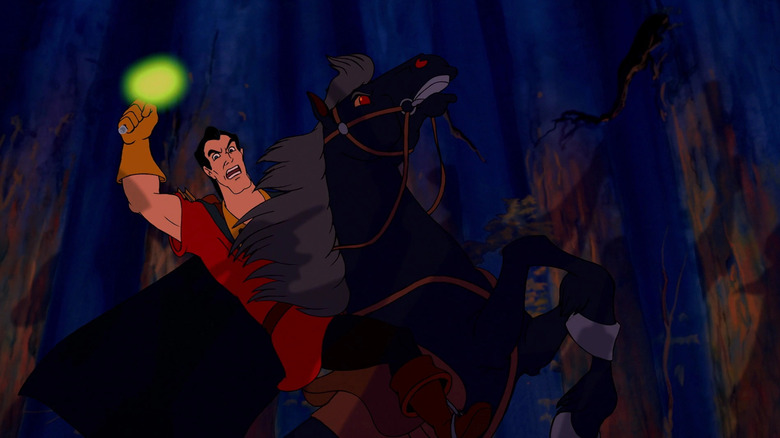 Gaston holding a torch