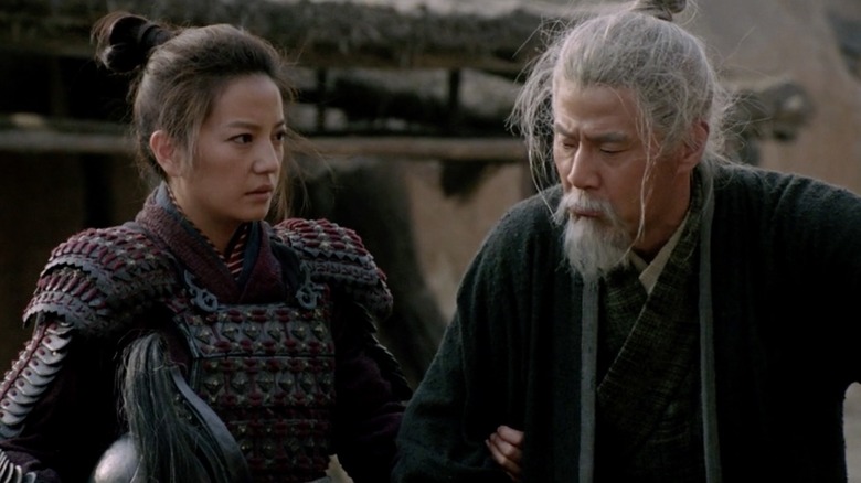 Mulan standing with her father