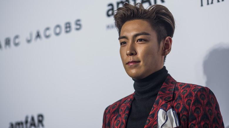 T.O.P on the red carpet in 2015 wearing a red jacket