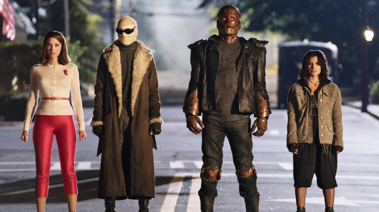 The Doom Patrol standing in the road