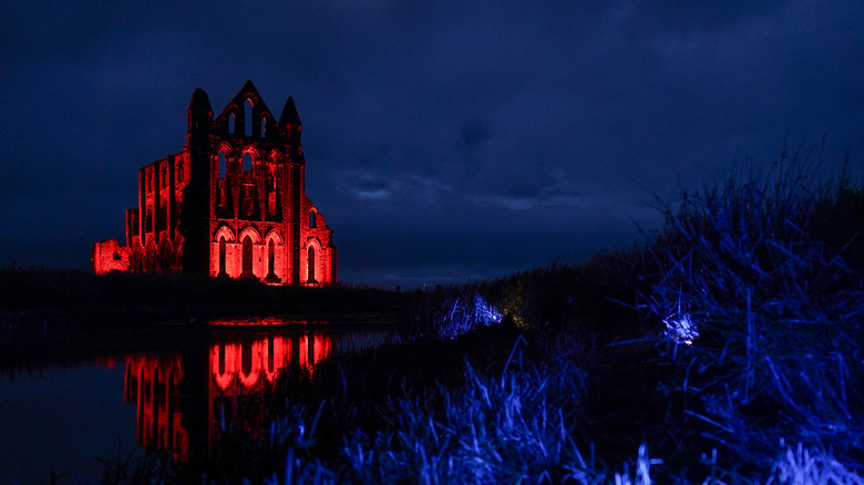 Whitby Abbey, night, lit red for English Heritage Dracula Season