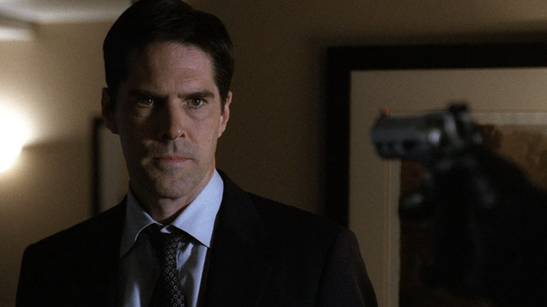 Thomas Gibson stares at gun