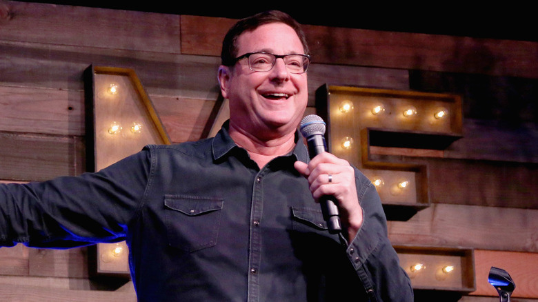 Bob Saget laughing on stage