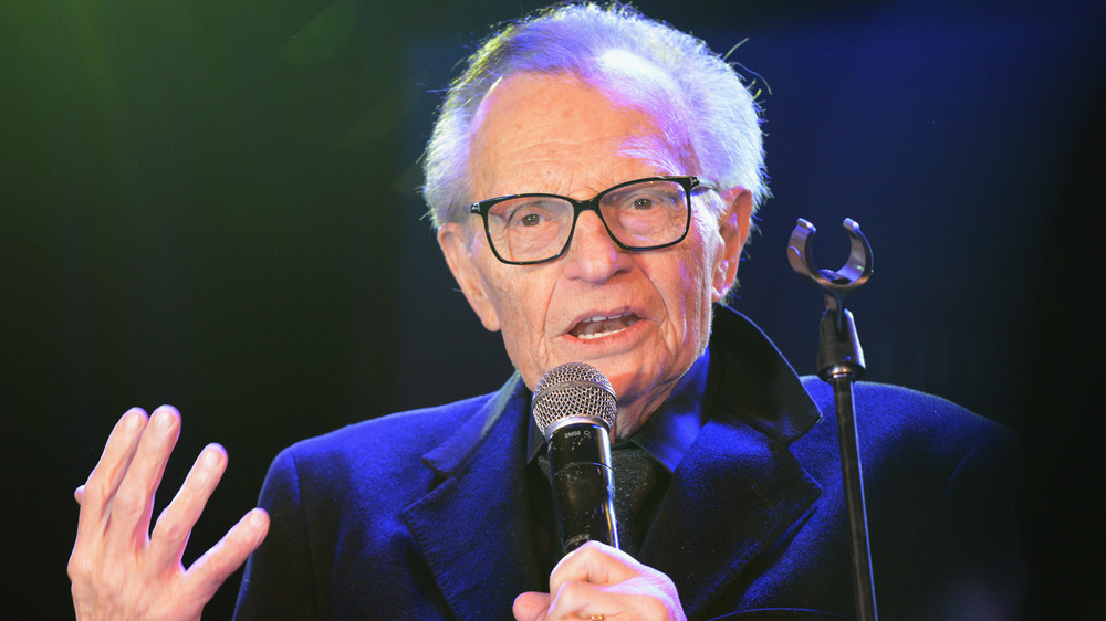 Larry King holding mic at the Roxy