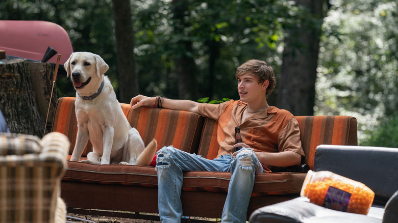 Johnny Berchtold sitting with dog