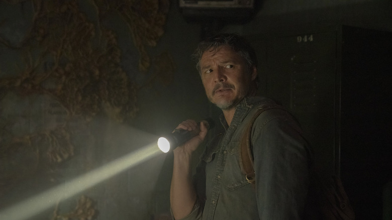 Joel with flashlight in The Last of Us