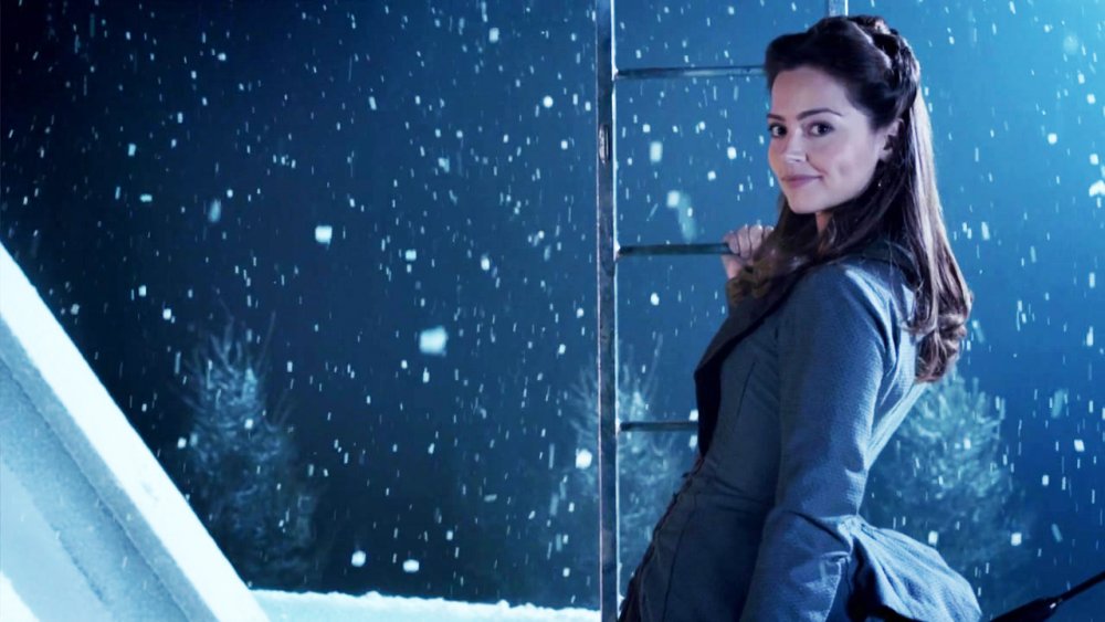 Jenna Coleman as Victorian governess Clara Oswin Oswald stands in the snow on Doctor Who