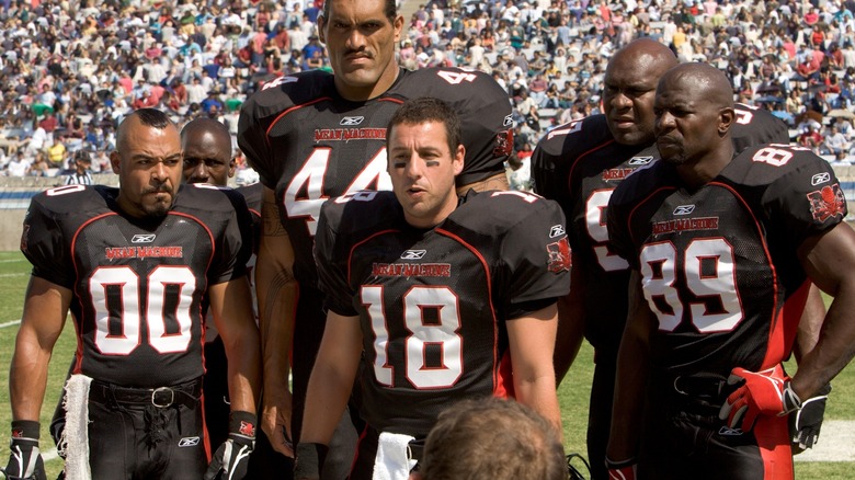 Members of a football team standing on the sideline