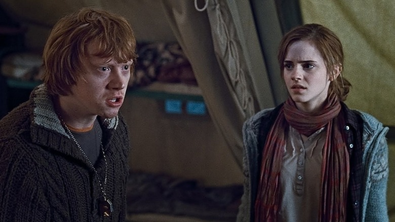 Ron yells at Harry while Hermione watches