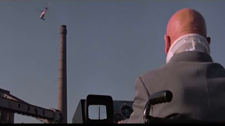 The back of Not-Blofeld's head as a helicopter approaches