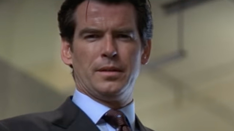 James Bond (Pierce Brosnan) looks down on a bloody printing press