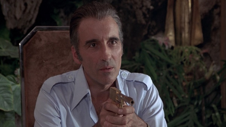 Scaramanga (Christopher Lee) with his golden gun in "The Man with the Golden Gun"