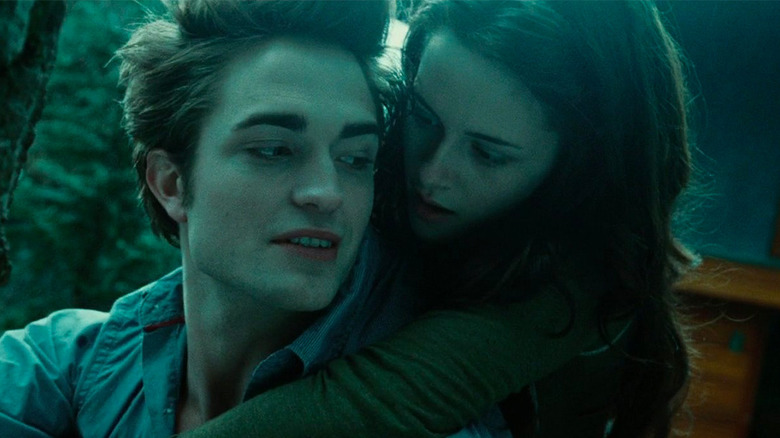 Edward carries Bella in forest