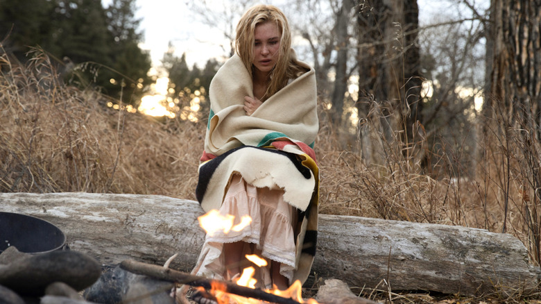 Elsa Dutton wrapped in blanket by fire