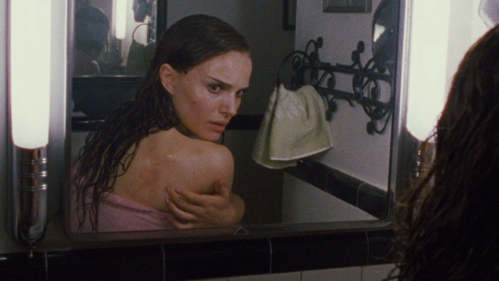 Natalie Portman as Nina Sayers examining her back in Black Swan