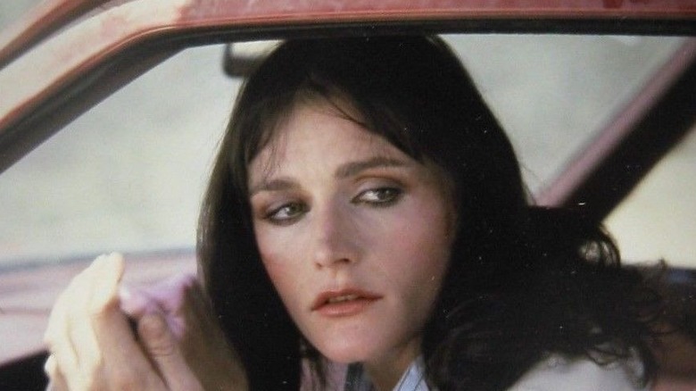 Margot Kidder looks over shoulder in car
