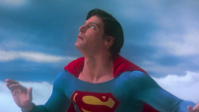 Christopher Reeve looking up while flying