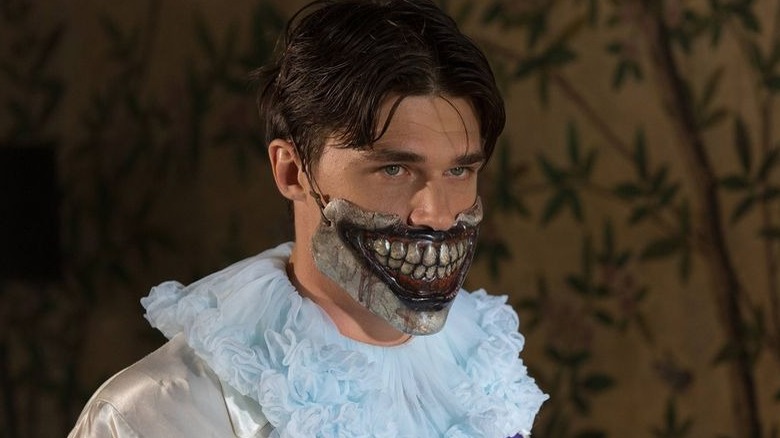 Finn Wittock as Dandy with clown mask in Freak Show