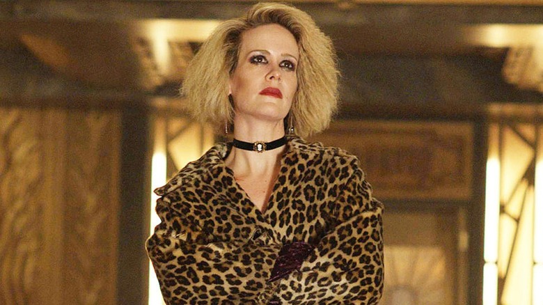 Sarah Paulson as Hypodermic Sally in cheetah print coat