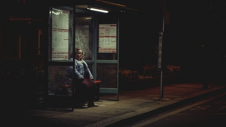 Martha alone at bus stop