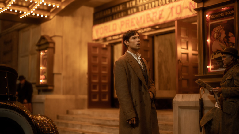 Manny Torres stands wistfully outside a theater