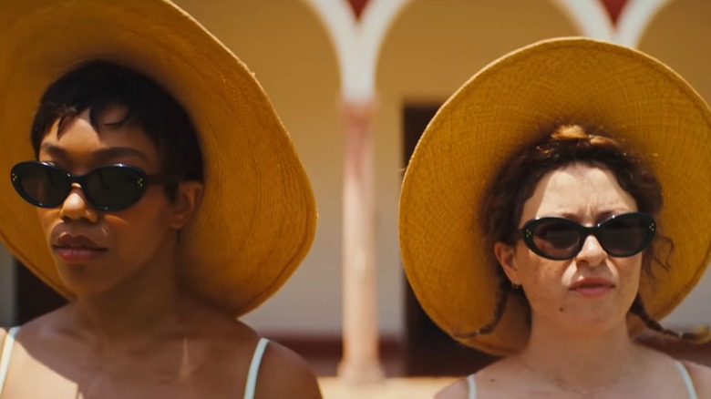 Frida and Jess wear straw hats in "Blink Twice" (2024)