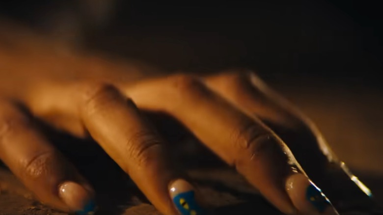 Frida's nails claw into dirt in "Blink Twice" (2024)