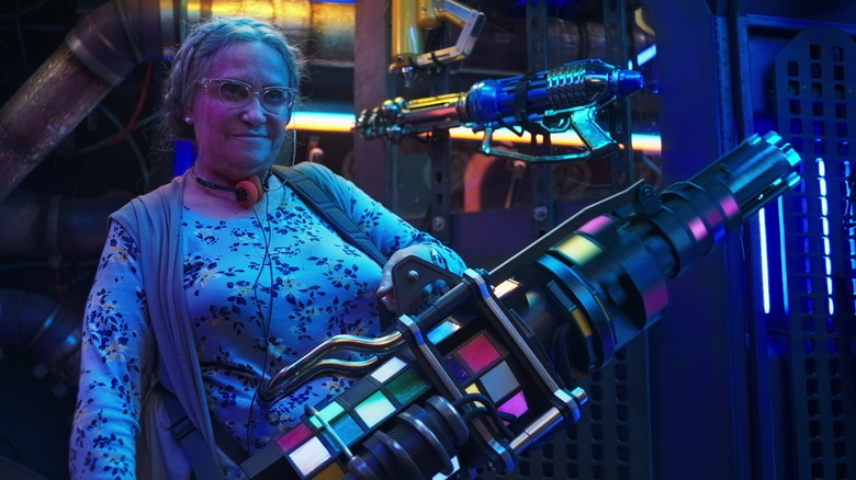 Nana holds a Gatling gun