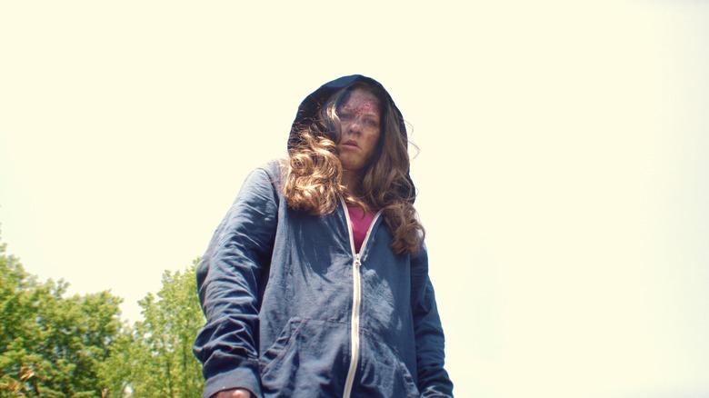 Jen wears hoodie looking down