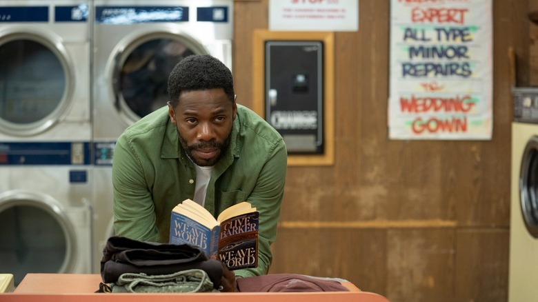 Burke reading novel in laundromat