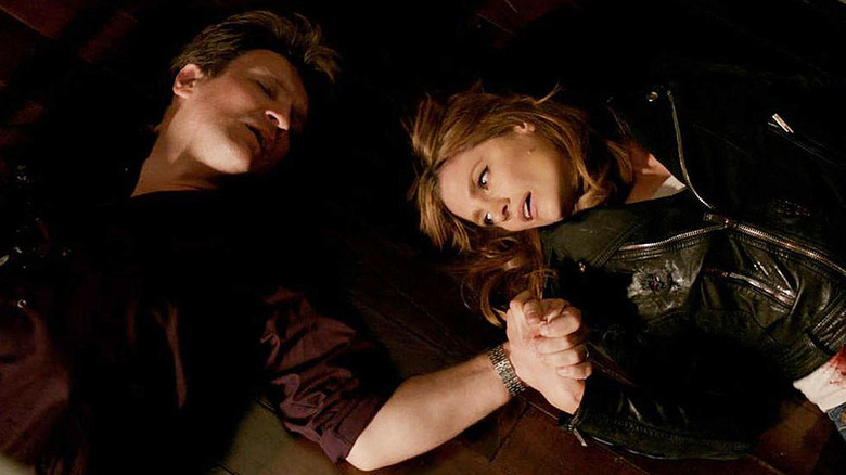 Castle and Beckett holds hands on floor after being shot