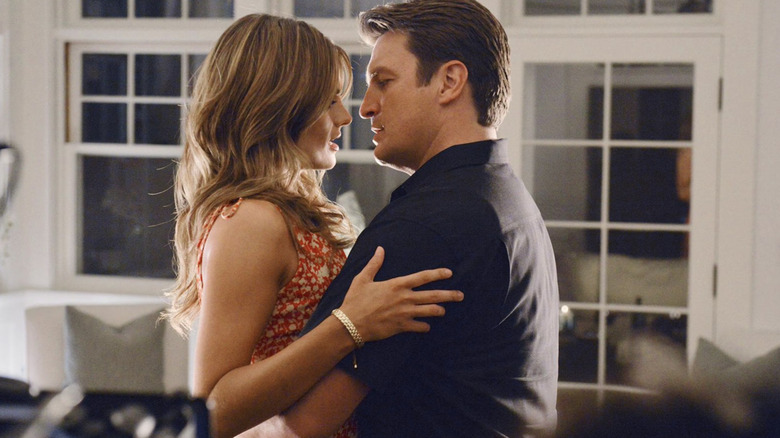 Castle and Beckett hold each other