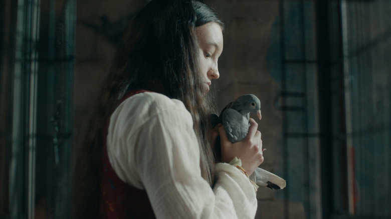 Bella Ramsey holding a bird