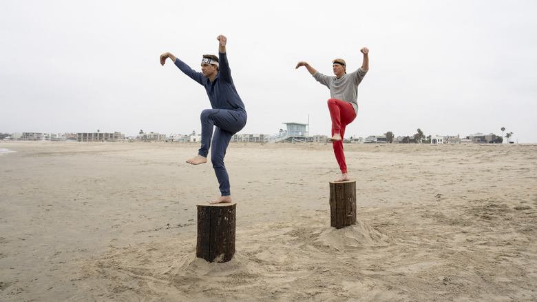 Daniel and Johnny balancing on stumps on Cobra Kai Season 6